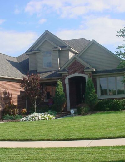 Suburban single-family home with well-manicured lawn and attached garage.